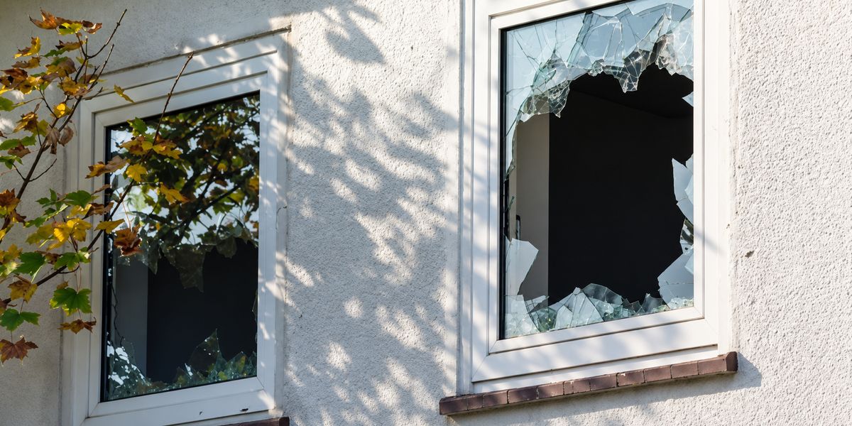 Shattered window in the outside wall of a house